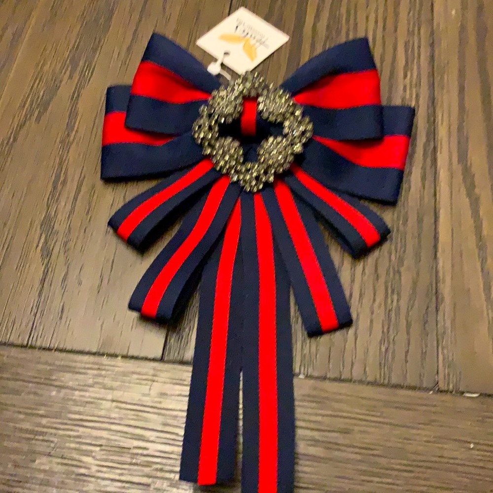 Red and blue striped brooch with pendant detail